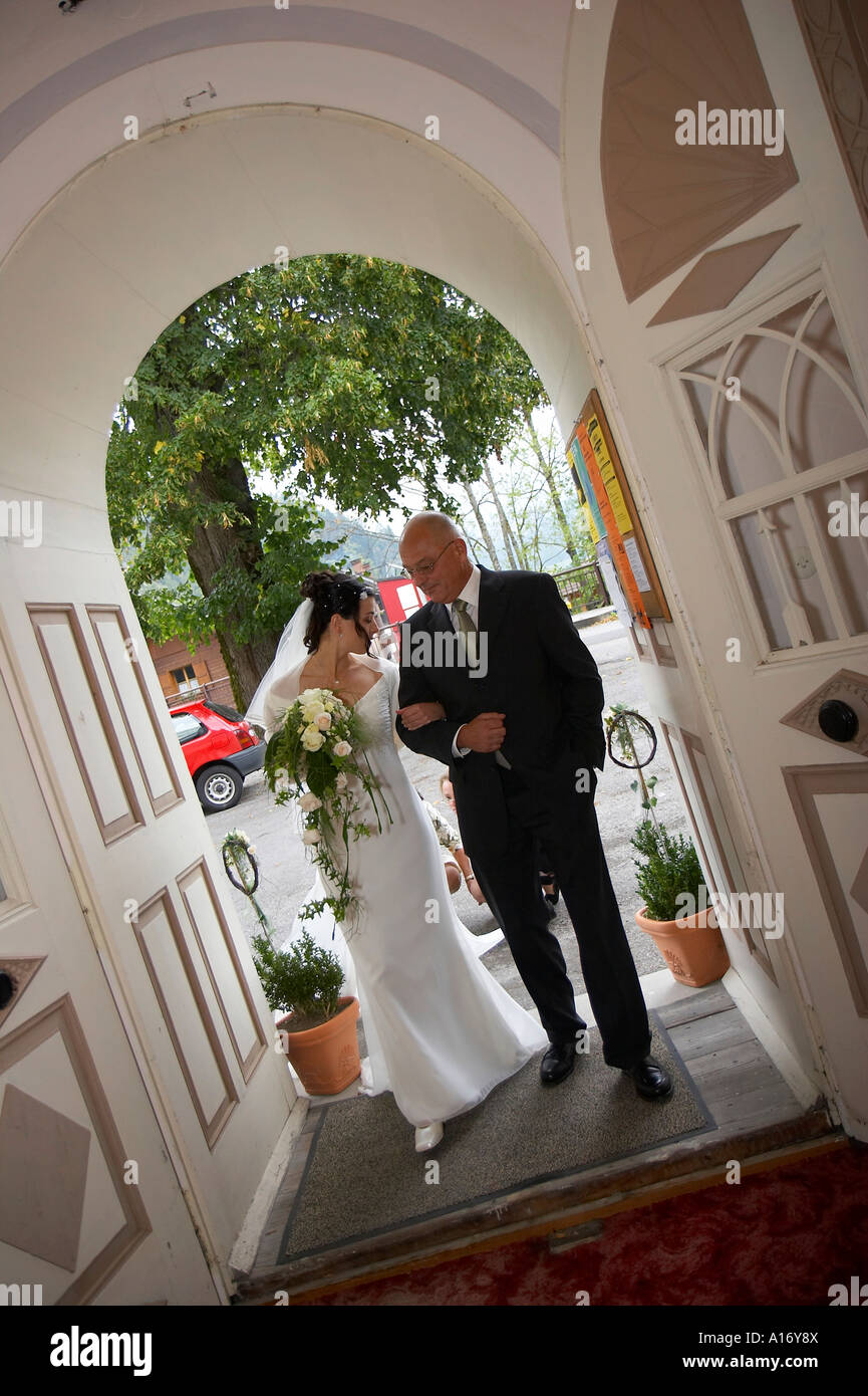 bride with father, entering church Stock Photo