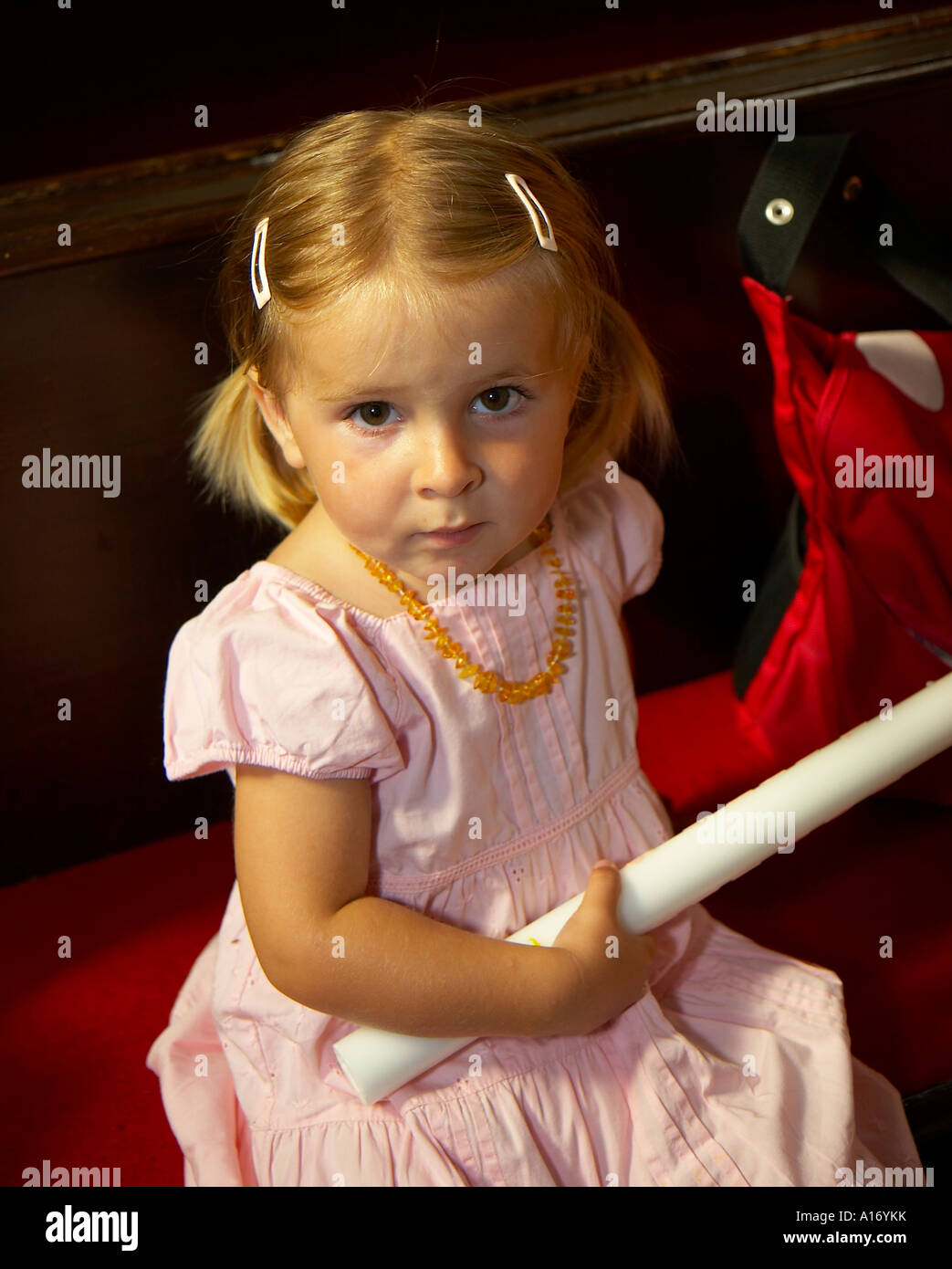 girl holding baptism candle Stock Photo Alamy