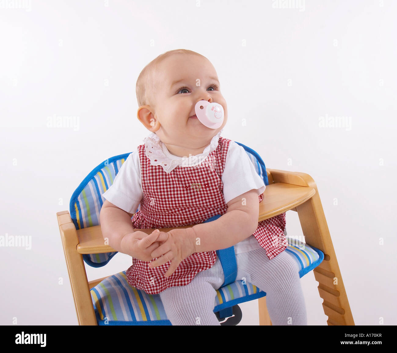 baby sitting in child seat Stock Photo