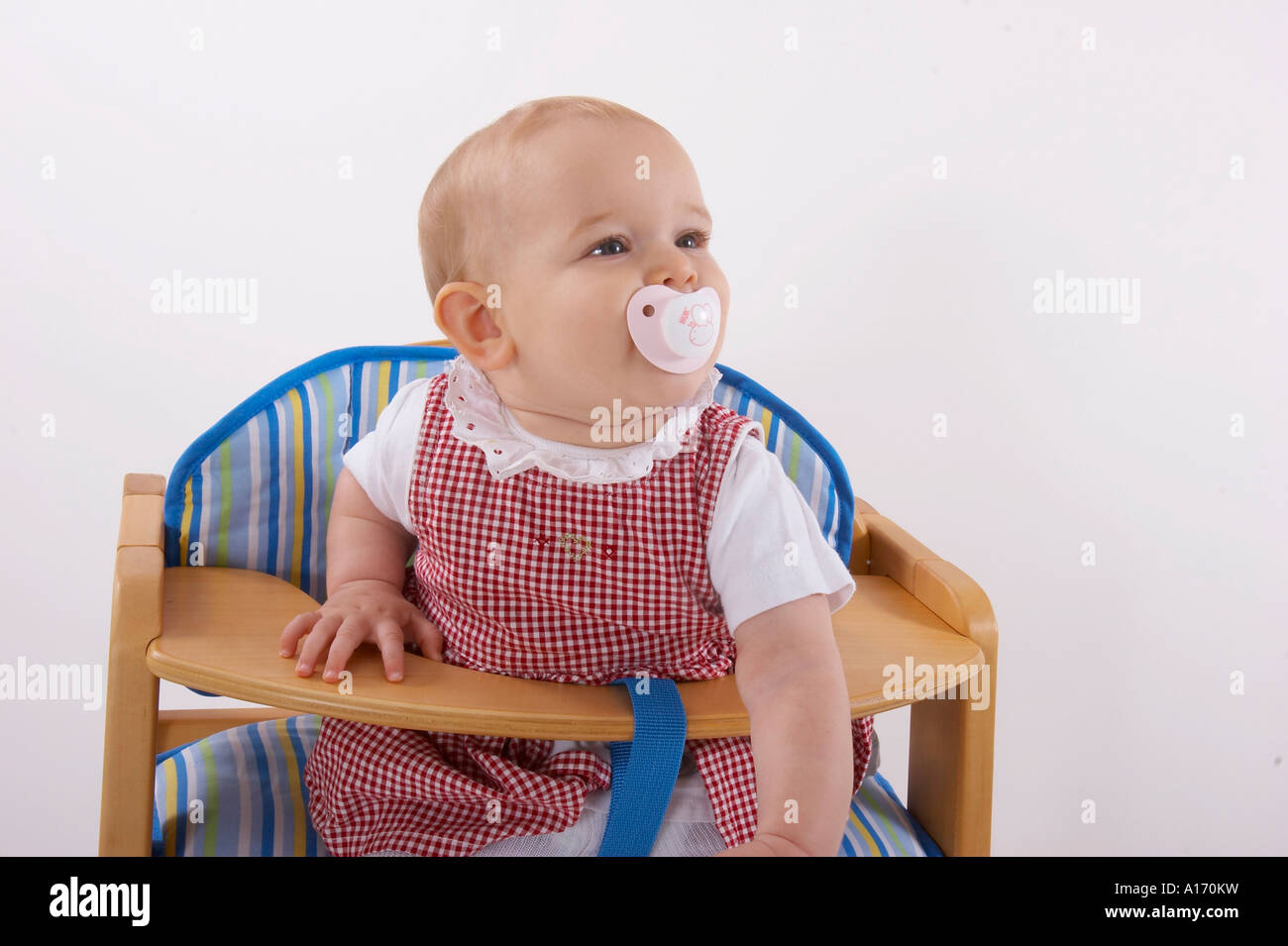 baby sitting in child seat Stock Photo