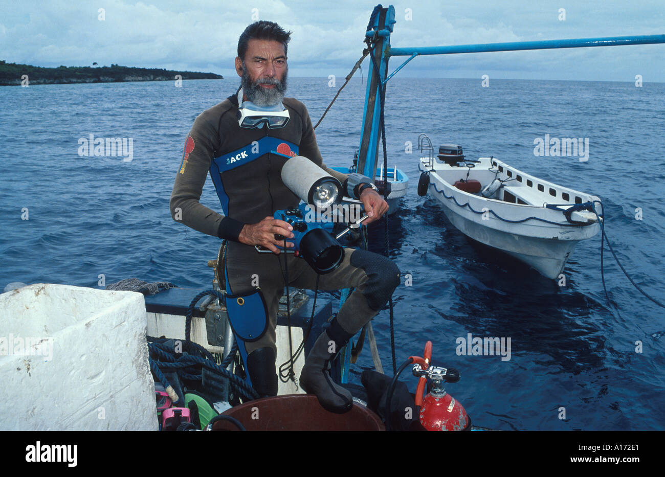 Jack Jackson with camera equipment between dives on live aboard boat in the Philippines Subject was then 54 years old Stock Photo