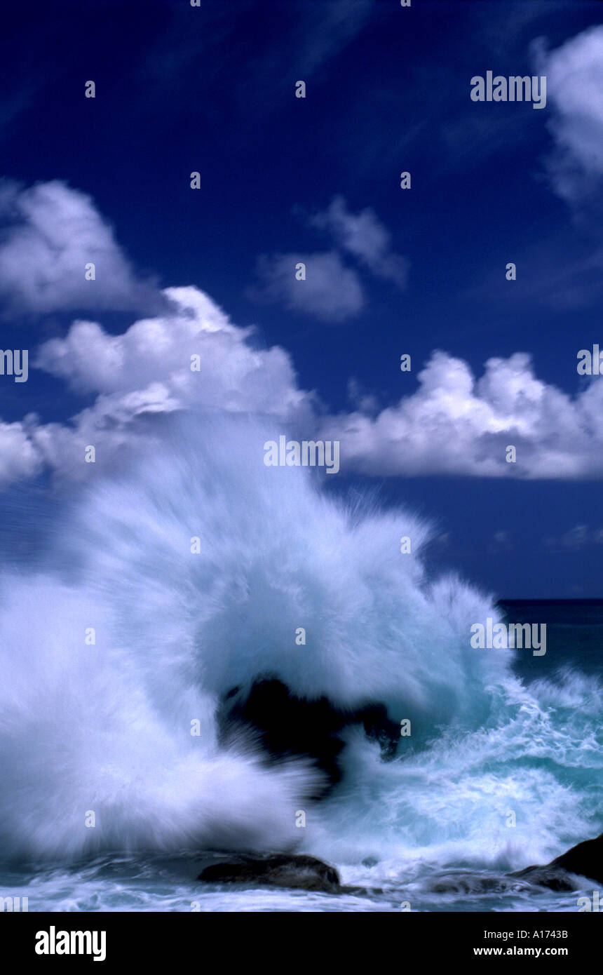 Wave crashing over rock Stock Photo Alamy