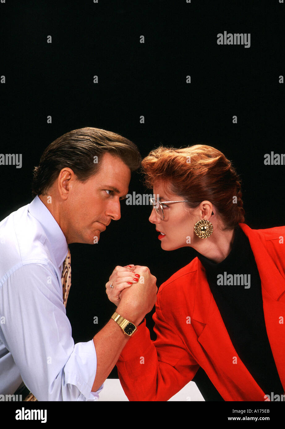 Battle of the Sexes Businessman and businesswoman arm wrestling competing Stock Photo