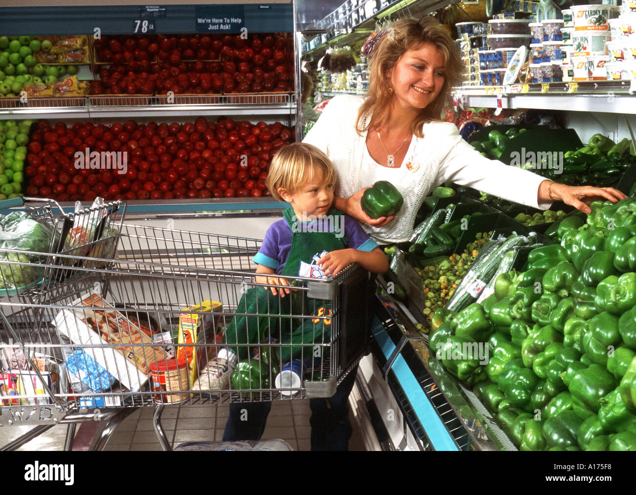 Mother and son shopping in the produce department of a grocery store