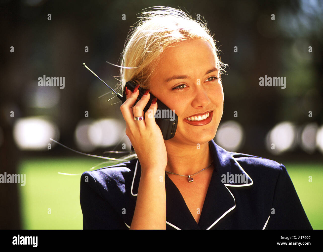 Attractive young businesswoman using cellular phone Stock Photo