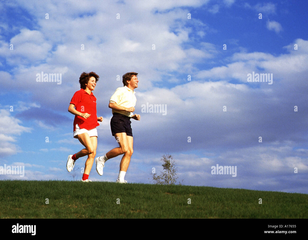 Attractive middle aged couple jogging together Stock Photo