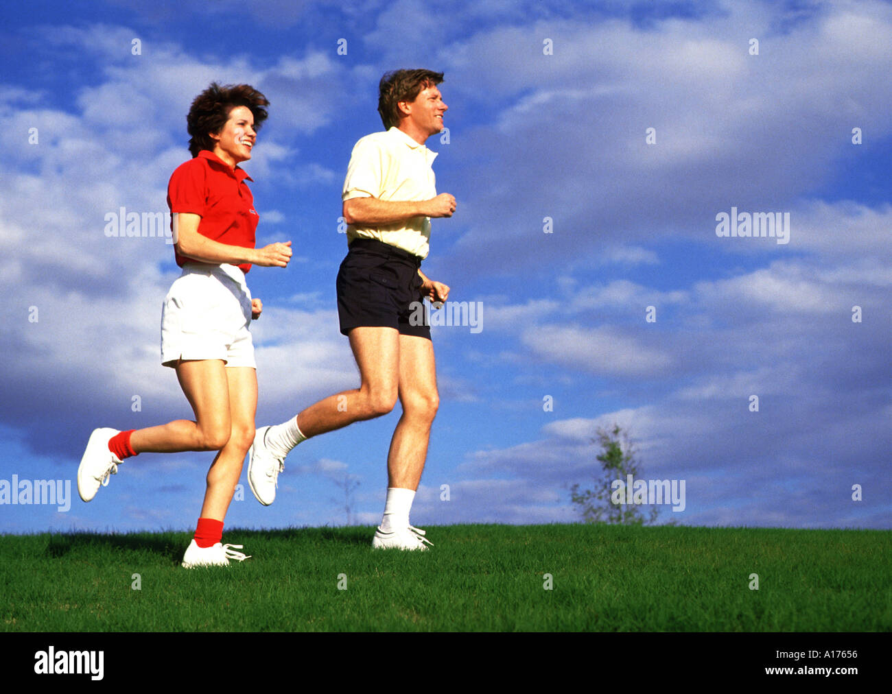 Attractive middle aged couple jogging together Stock Photo