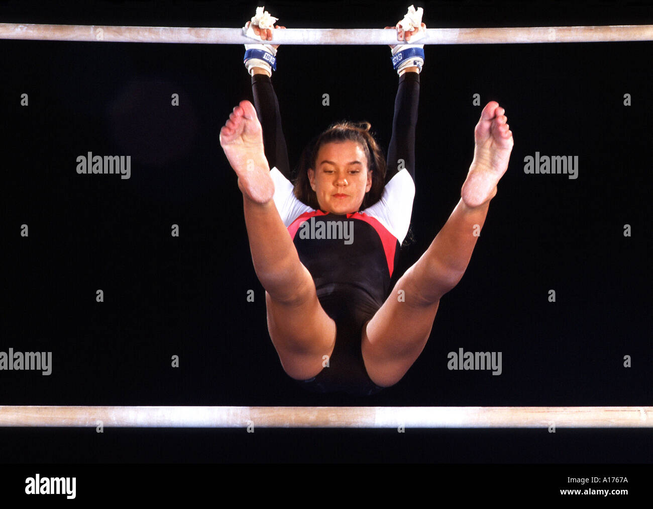 Young female gymnast on the uneven bars Stock Photo Alamy
