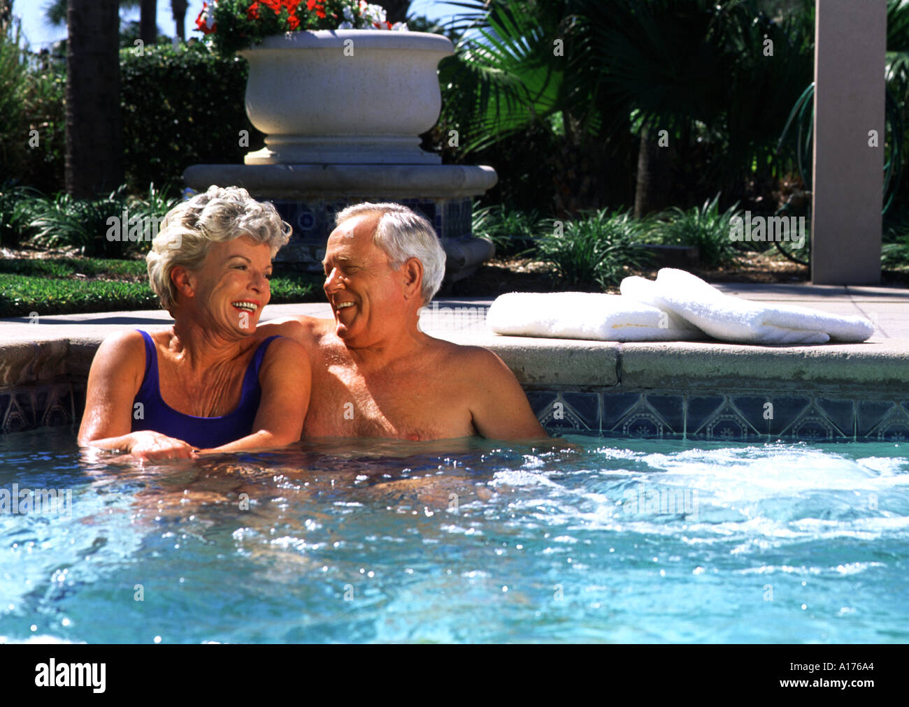 Retired couple relaxing in the pool Stock Photo - Alamy