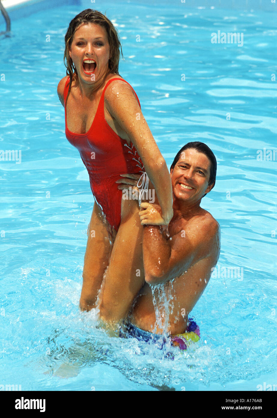 Attractive middle aged couple playing in the pool Stock Photo