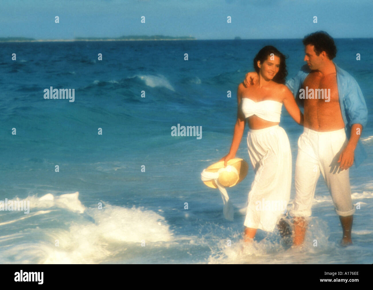 Attractive young couple walking on the beach Stock Photo