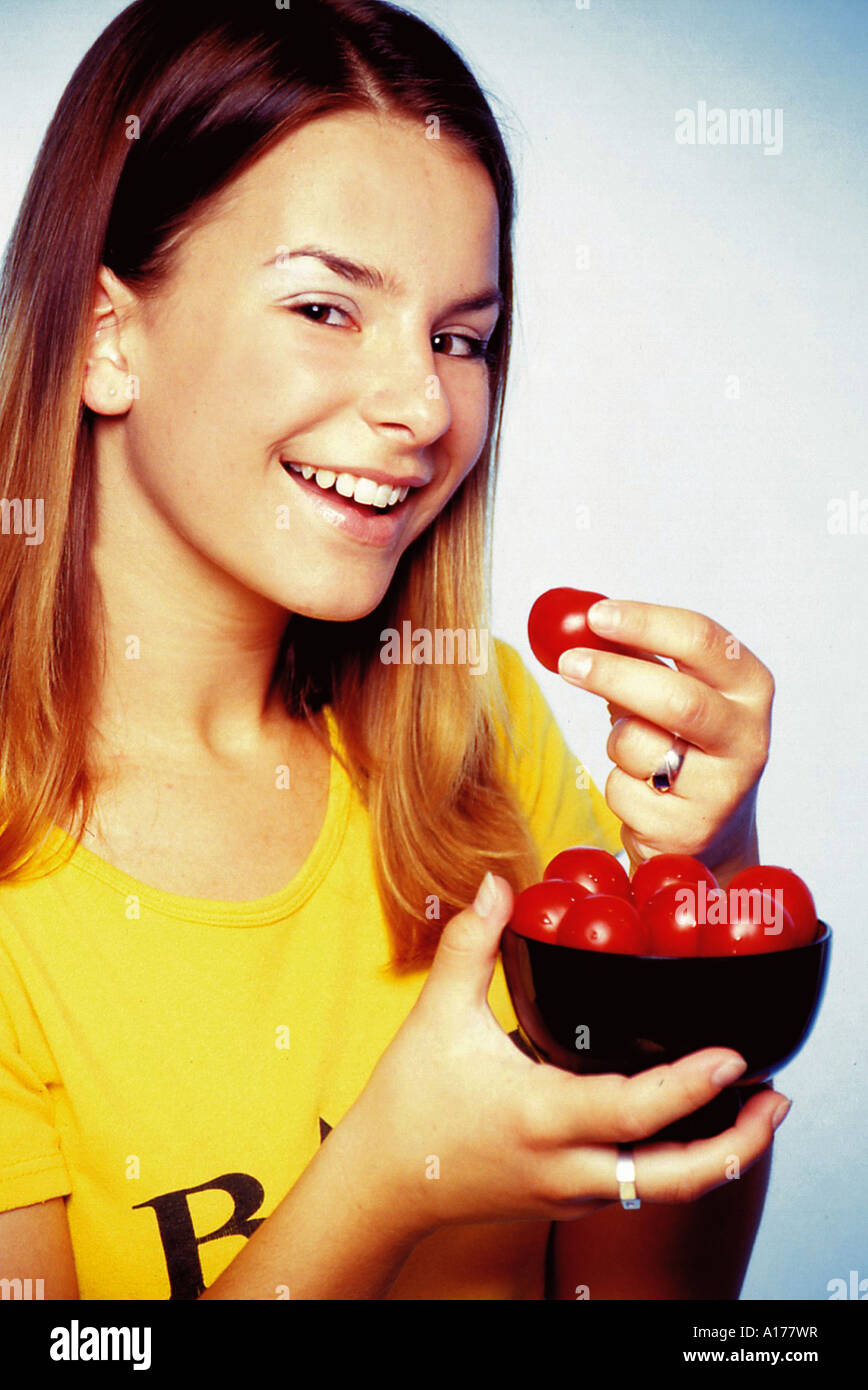 Woman eats tomatoes Stock Photo