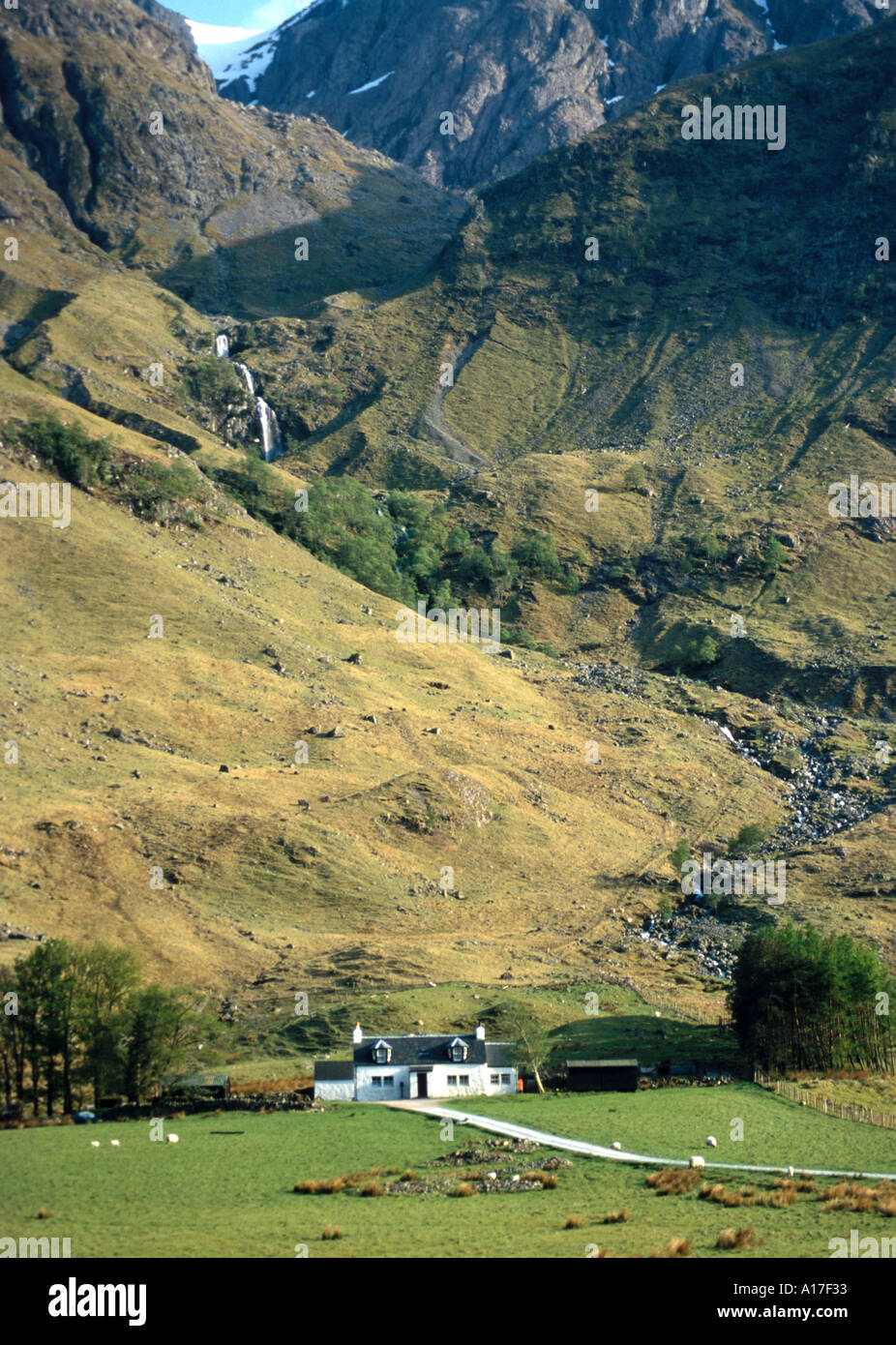 Glencoe in Scotland with a white house Stock Photo Alamy