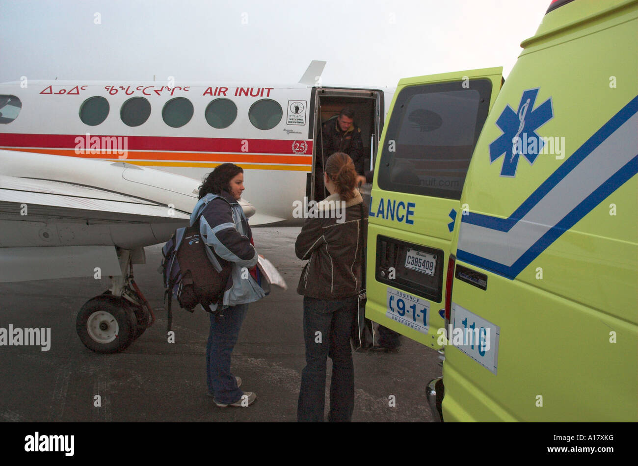 Young doctors getting ready to board a plane for an emergency medical evacuation in the arctic town of Kuujjuaq Stock Photo