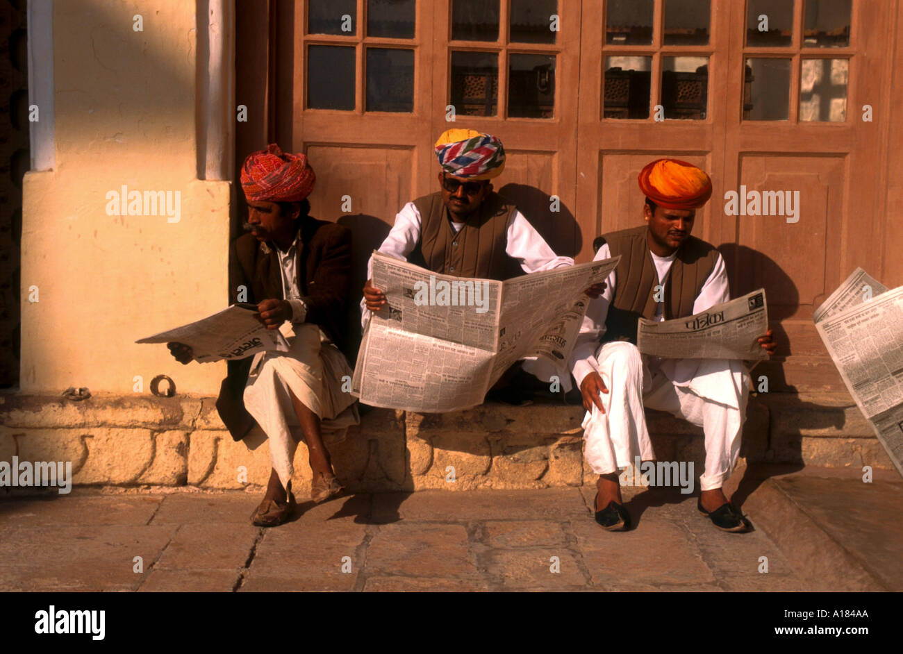 Group of men sitting reading newspapers Jodhpur Rajasthan India Robert Harding Stock Photo