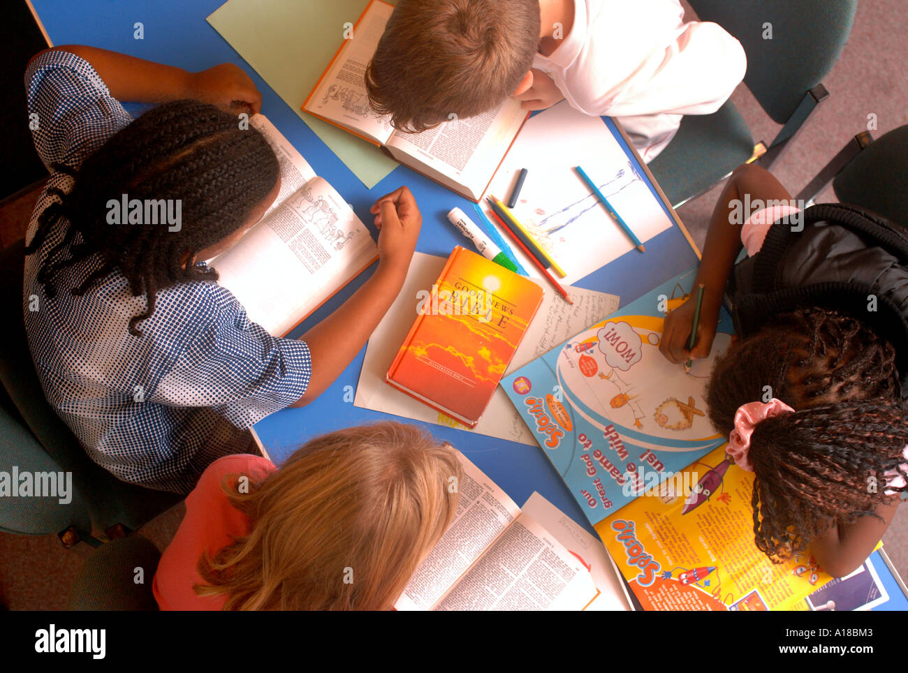 A CHILD COLOURING IN A DRAWING AT A SUNDAY SCHOOL UK Stock Photo