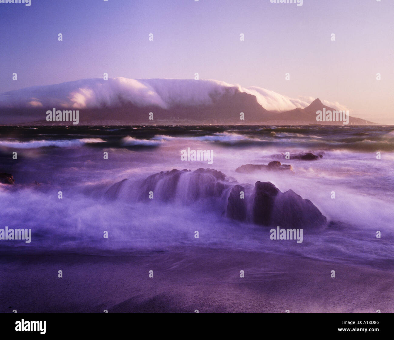Table mountain at sunset covered by table cloth clouds Cape Town South Africa Stock Photo