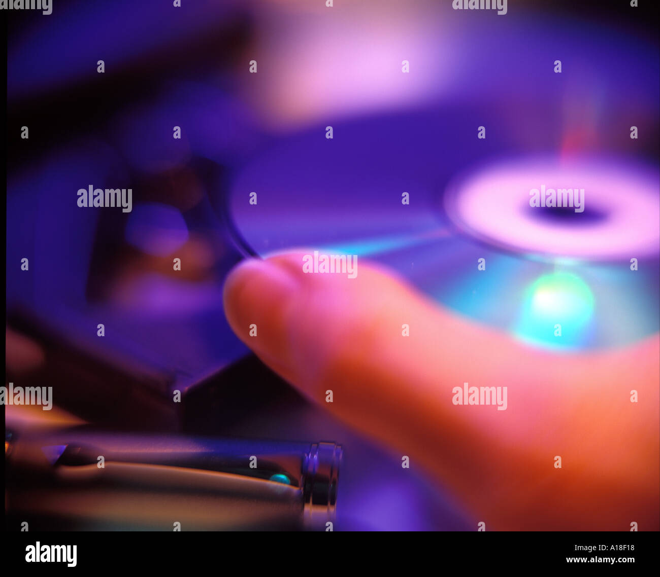 Putting CD into computer Stock Photo Alamy