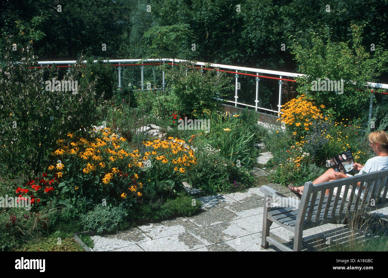 roof garden, with woman sitting on garden bench Stock Photo - Alamy