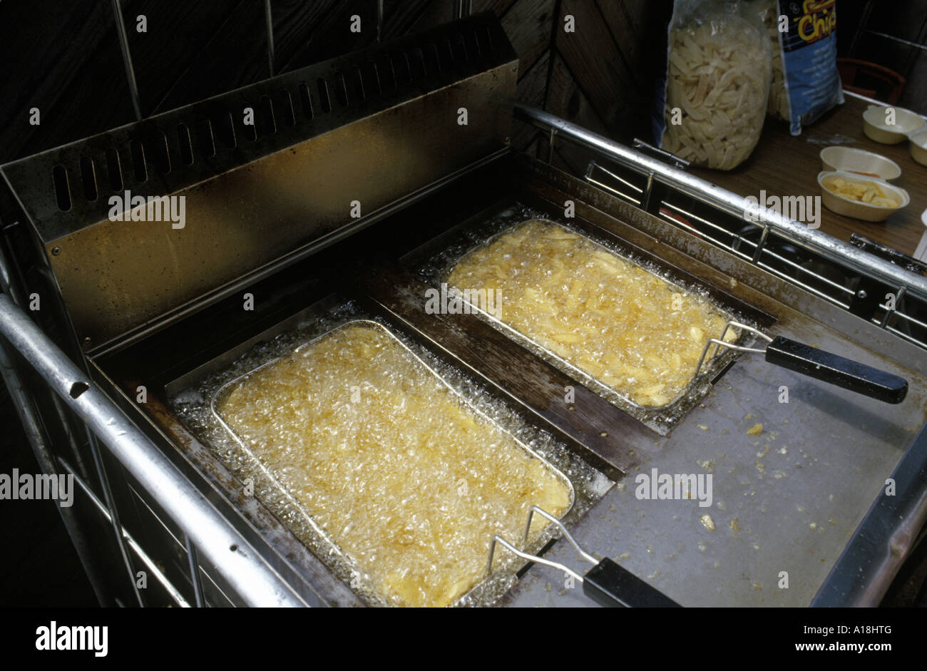 chips in a deep fat fryer Stock Photo Alamy