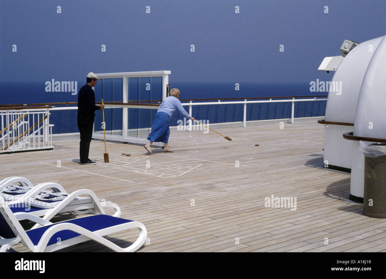 a couple playing deck shuffleboard on a cruise ship Stock Photo Alamy