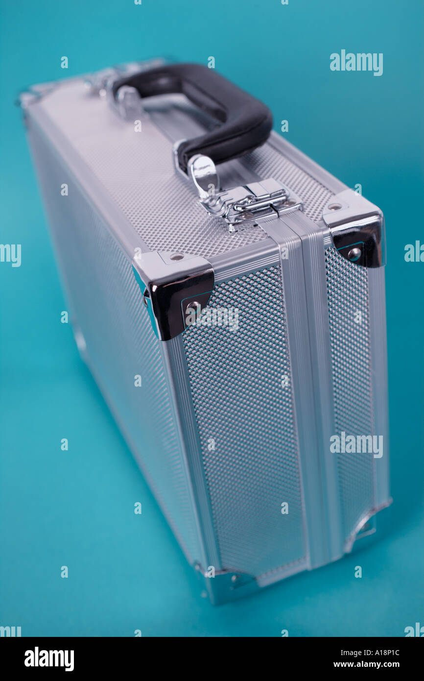 Suitcase made of aluminum on turquoise background Stock Photo Alamy