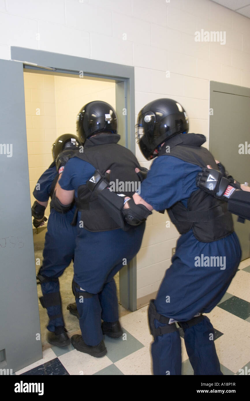 Cell extraction team preparing to enter cell to handle unruly inmate