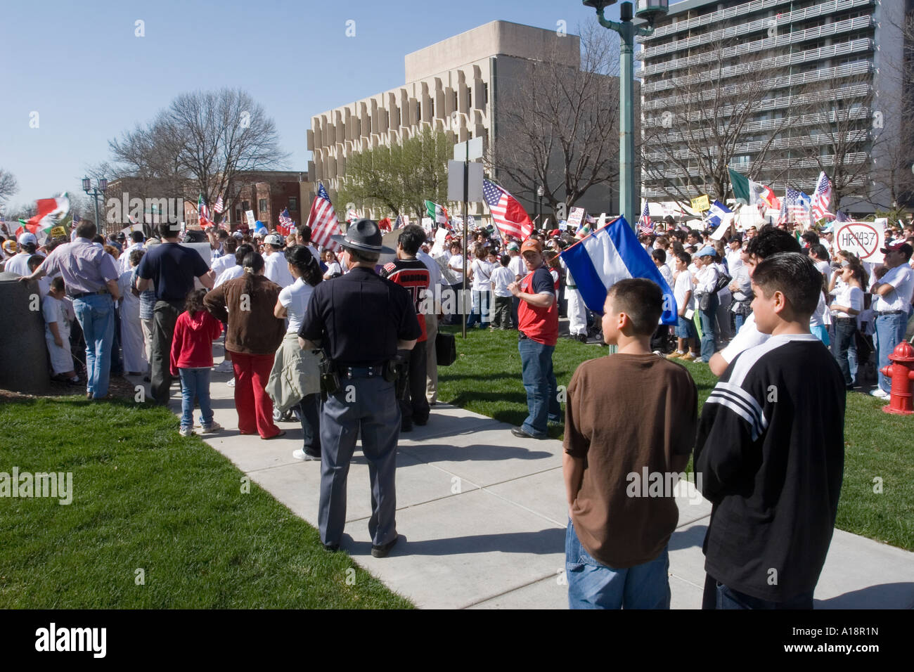 Nebraska State Trooper looking on as a demonstration for immigrant rights goes on in Lincoln Nebraska Stock Photo