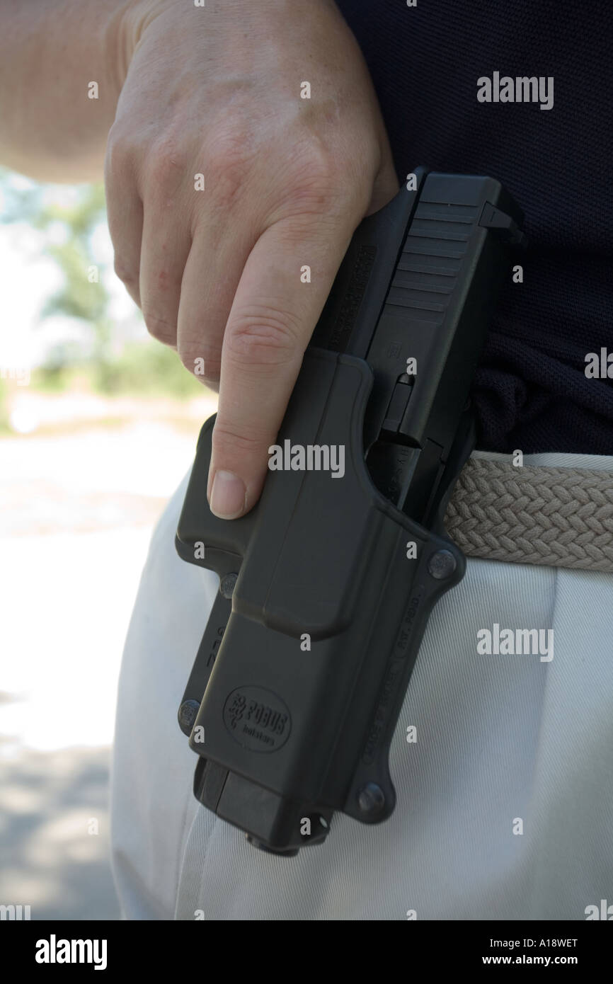 Glock model 22. .40 caliber in paddle type holster. Female