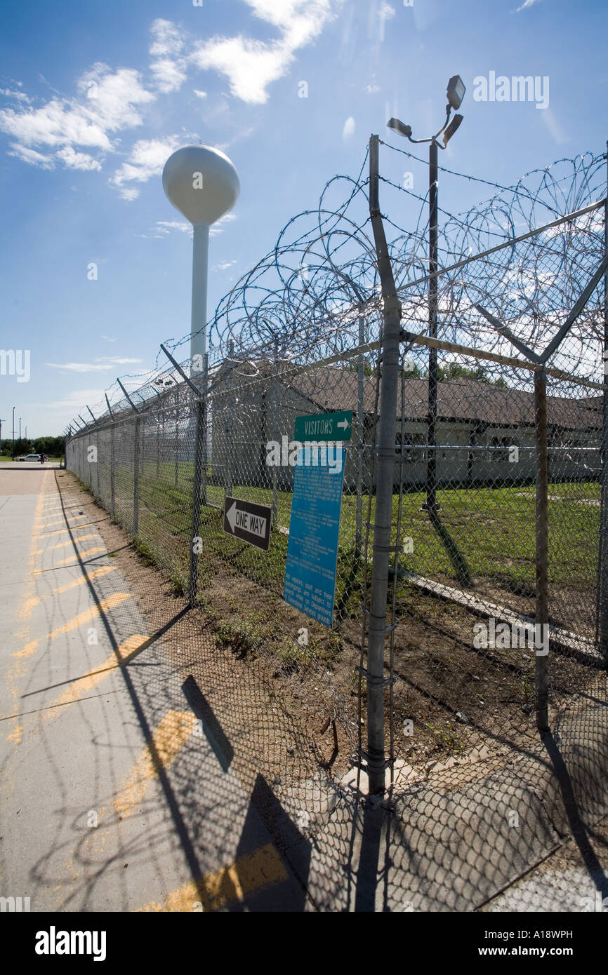 Perimeter fence and water tower at the Nebraska Correctional Center for Women in York Nebraska USA Stock Photo