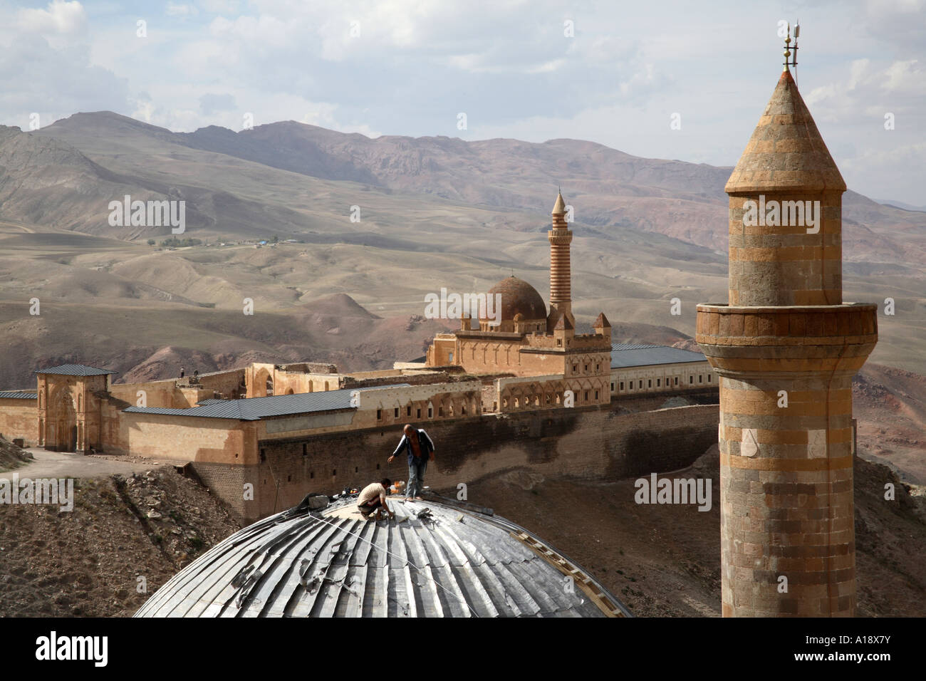 Men constructing roof on mosque in front of Ishak Pasha Palace. Dogubeyazit, Agri, Turkey Stock Photo