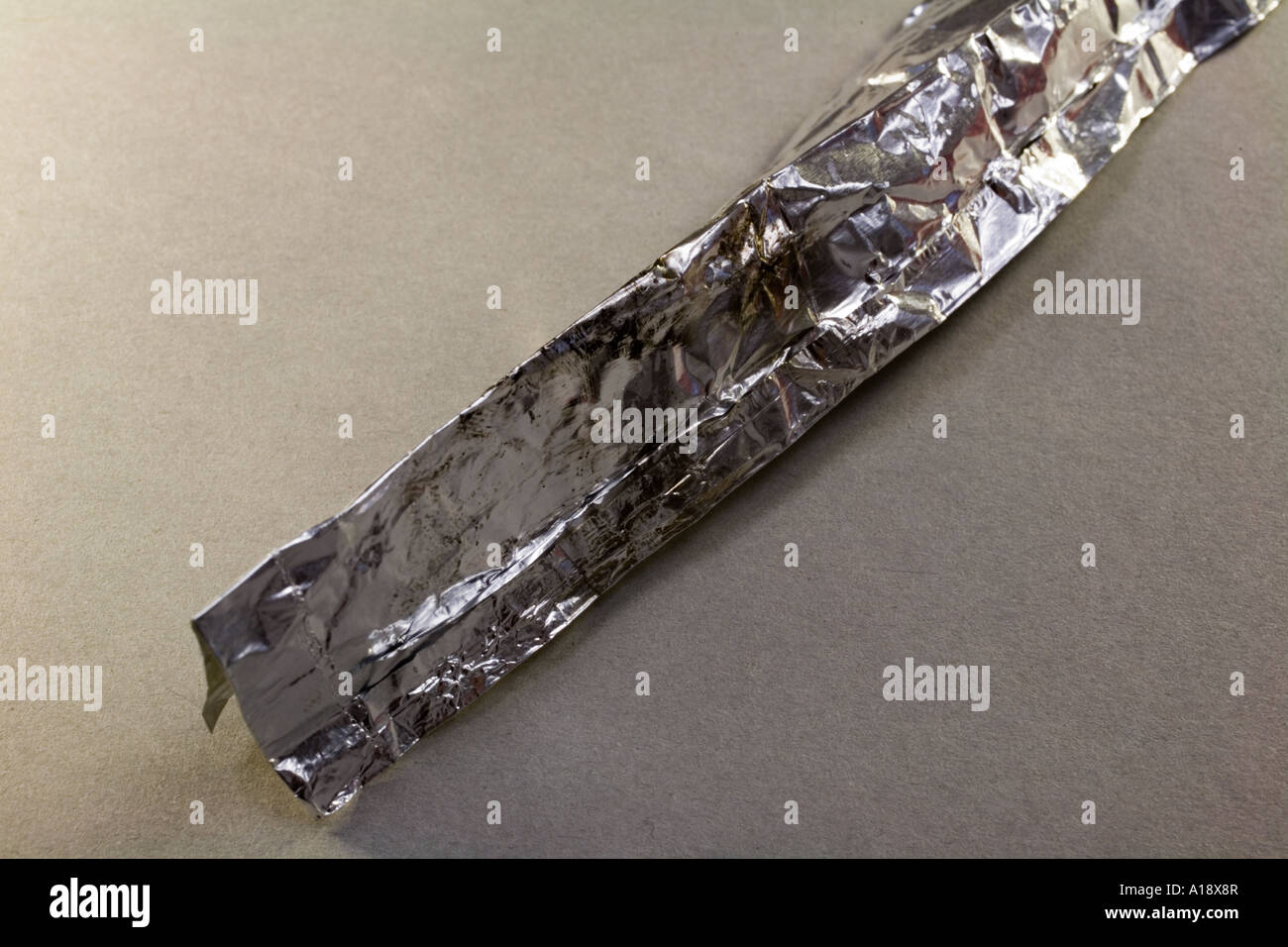 Tin foil with burn marks and meth residue Located during search warrant Stock Photo