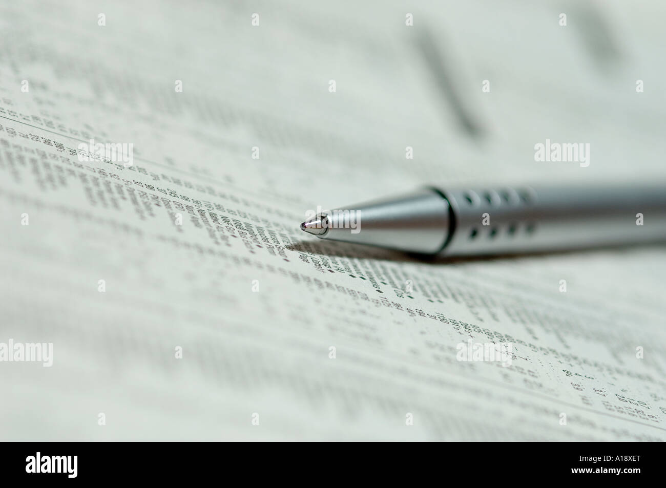 Close up of ballpoint pen on newspaper business concept Stock Photo