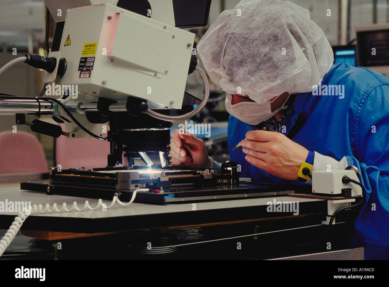 inspecting computer micro chip Amdahl Co CA Stock Photo