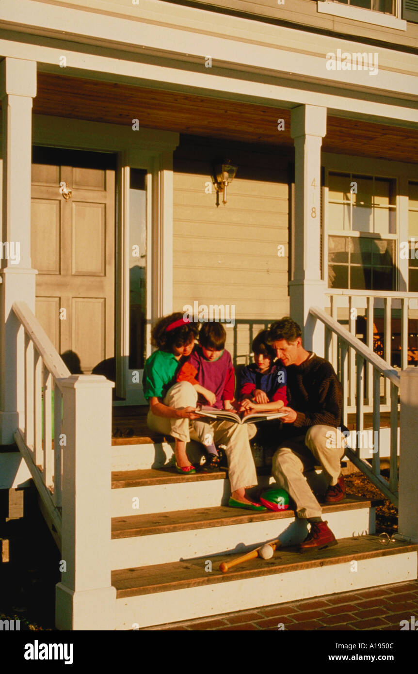 Happy family relaxing on porch hi-res stock photography and images - Alamy