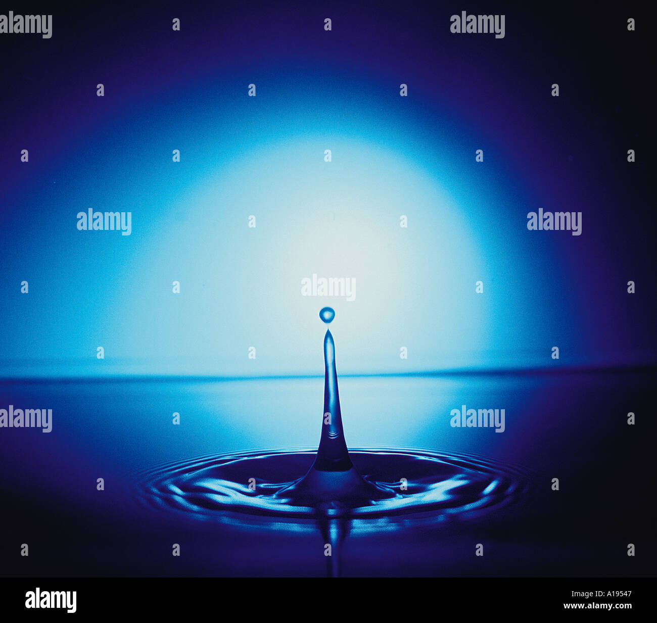 Water drop with blue light Stock Photo - Alamy