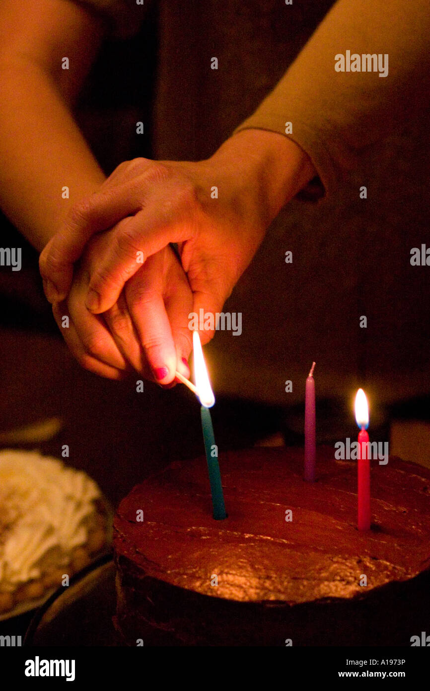 Mom helping light birthday candles. St Paul Minnesota USA Stock Photo