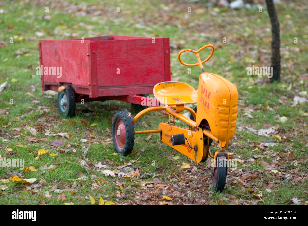 Antique Minneapolis Moline MM toy tractor pulling red trailer