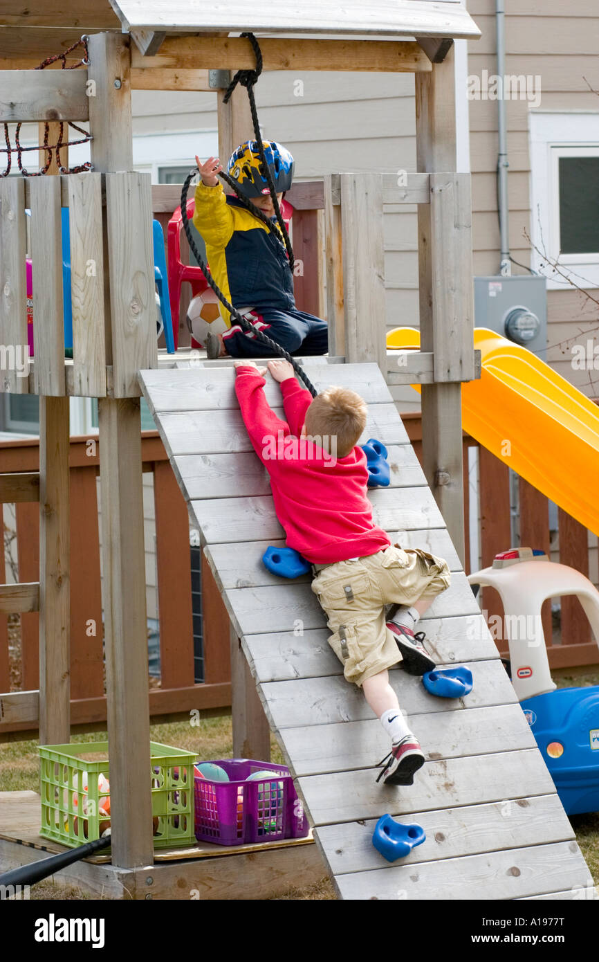 Boy age 5 climbing ramp to elevated play house. St Paul Minnesota USA ...