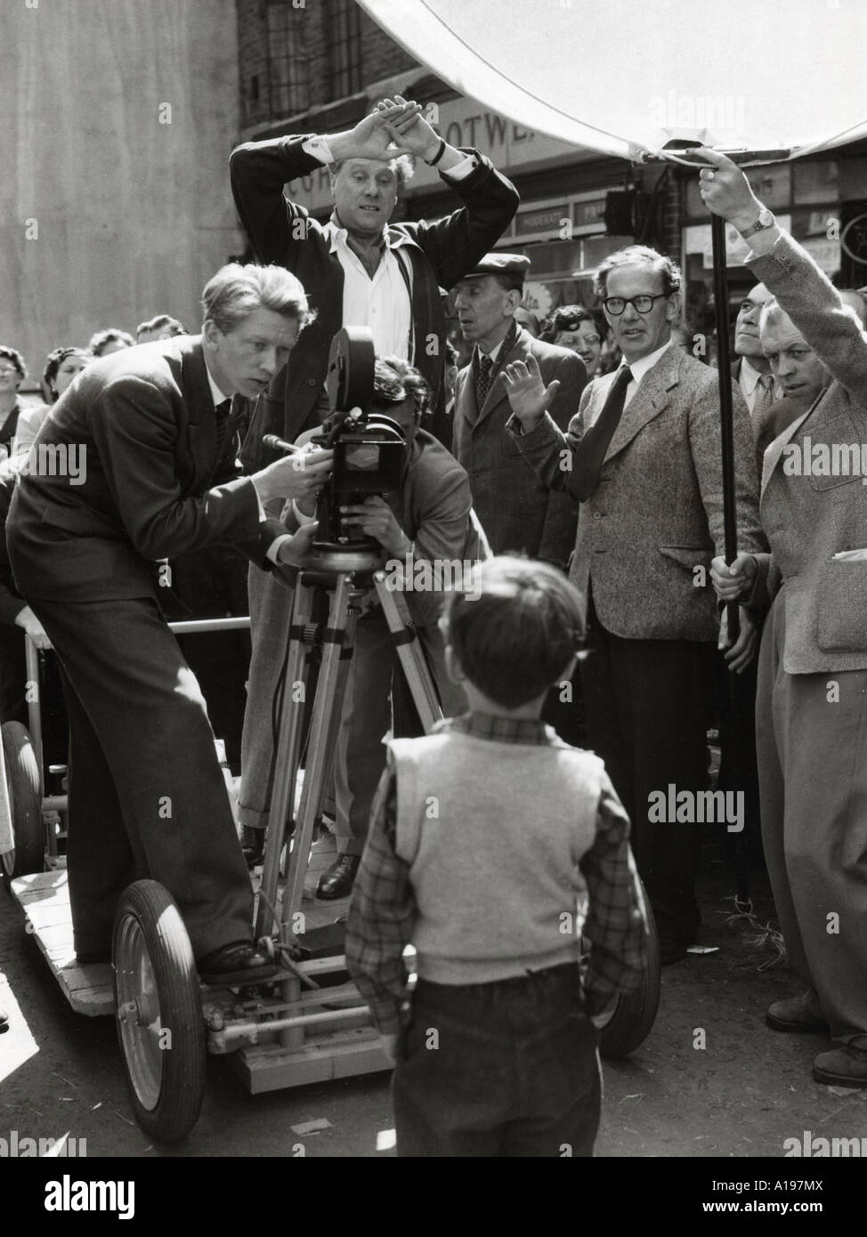 A KID FOR TWO FARTHINGS Carol Reed hands raised directing Jonathan Ashmore on location in 1954 Stock Photo