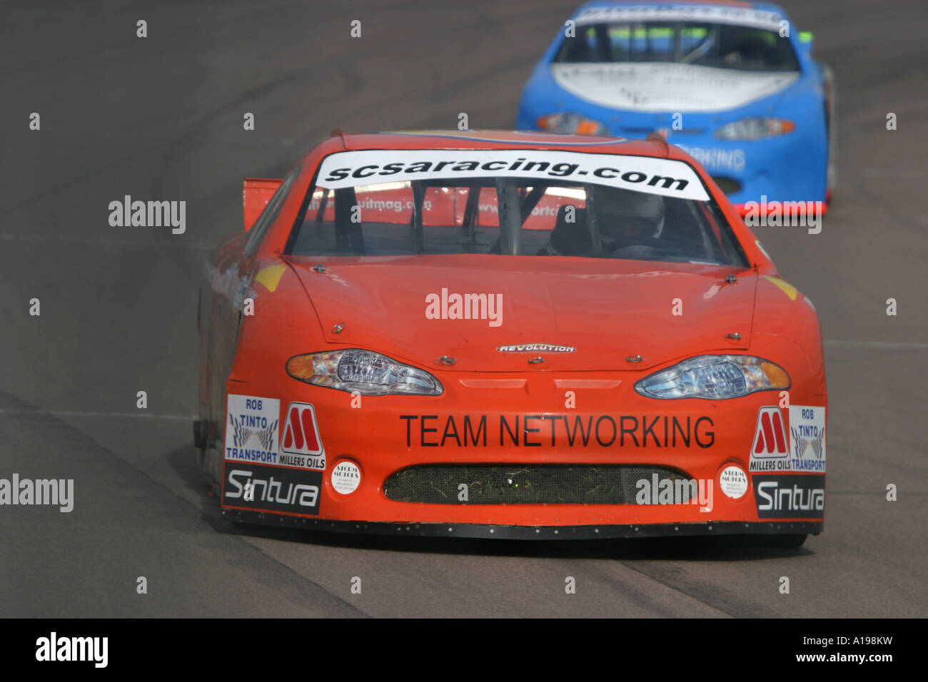 V8 Nascar type stock cars racing on a banked oval circuit Stock Photo ...