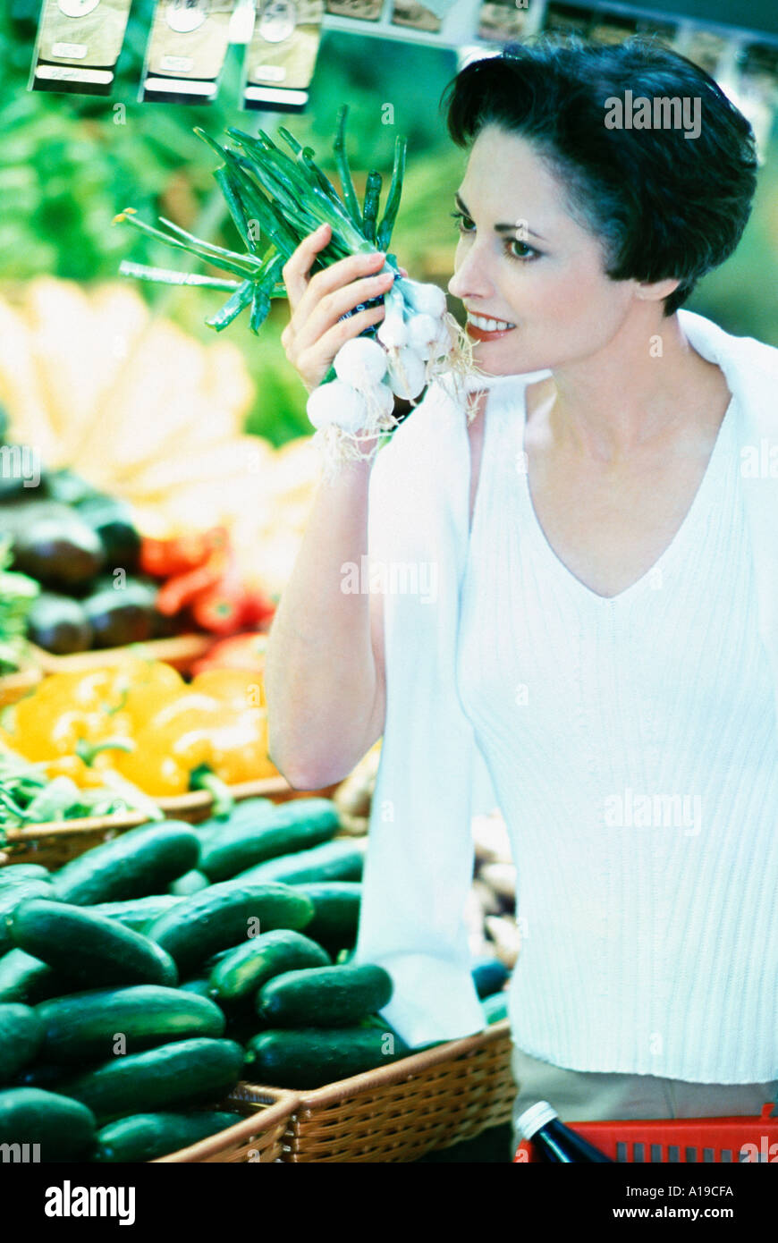 Woman shopping for produce in grocery market Stock Photo