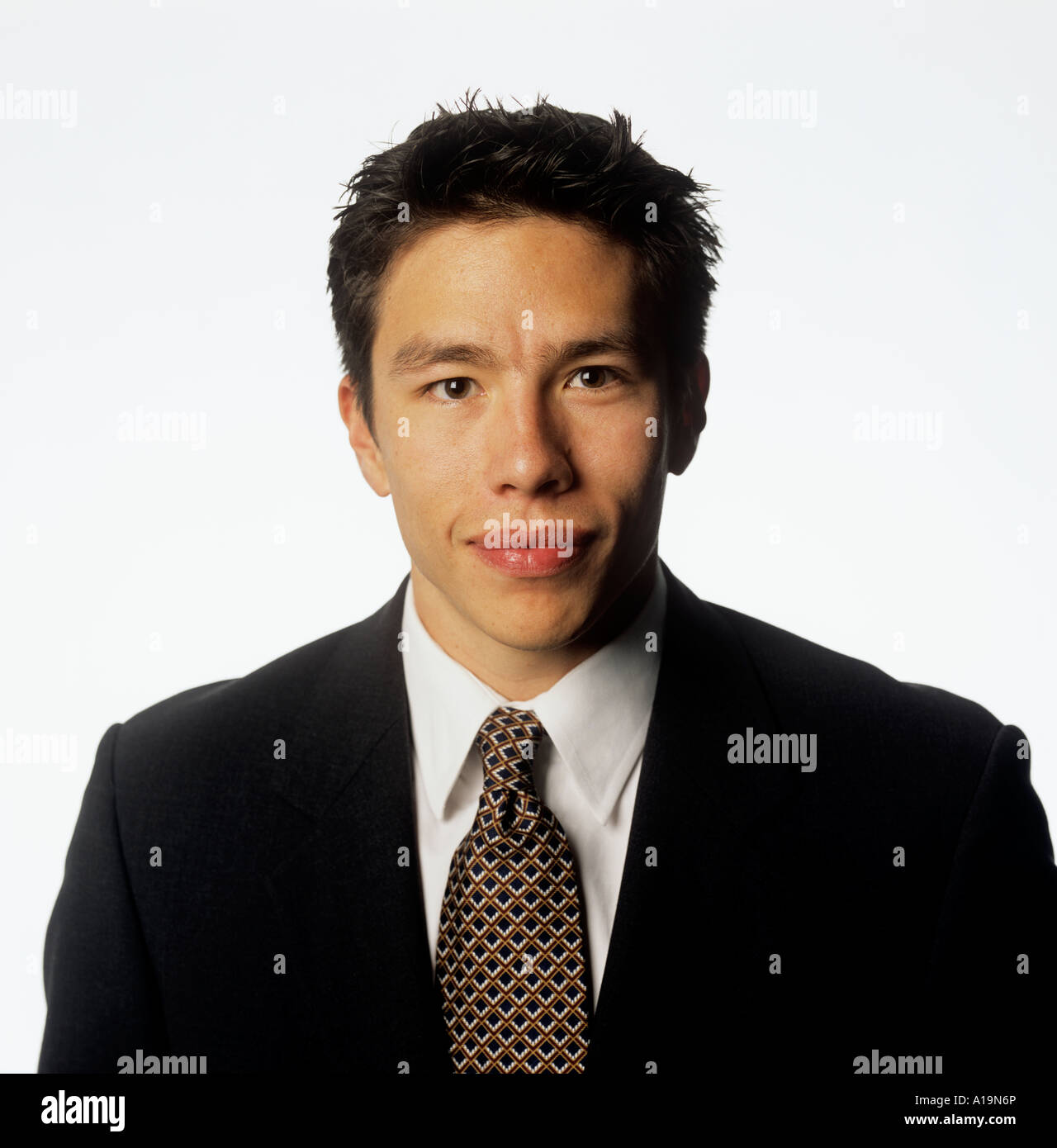 An asian american businessman listens attentively as project is discussed Stock Photo