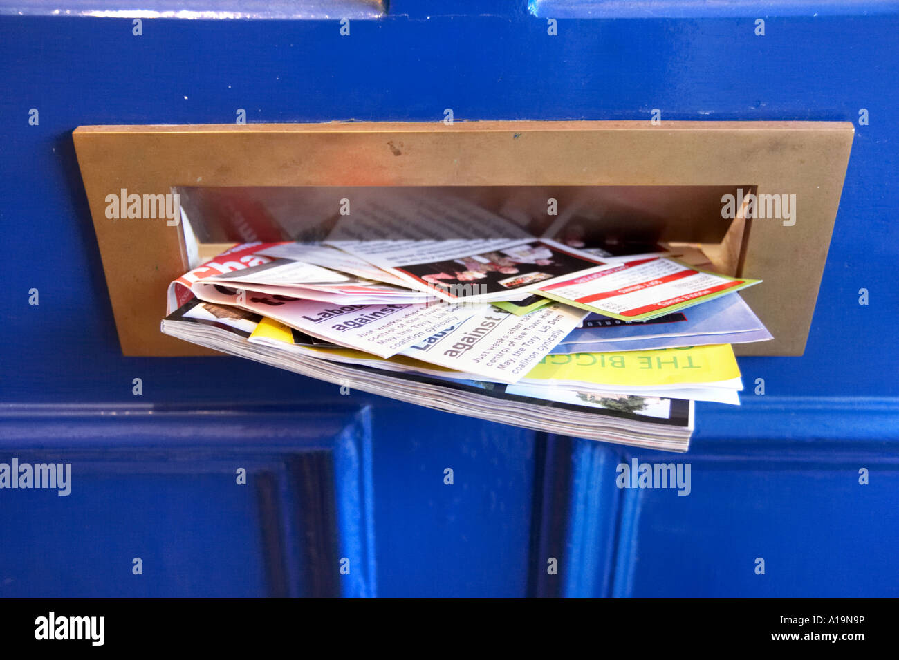 Junk mail through the postbox Stock Photo