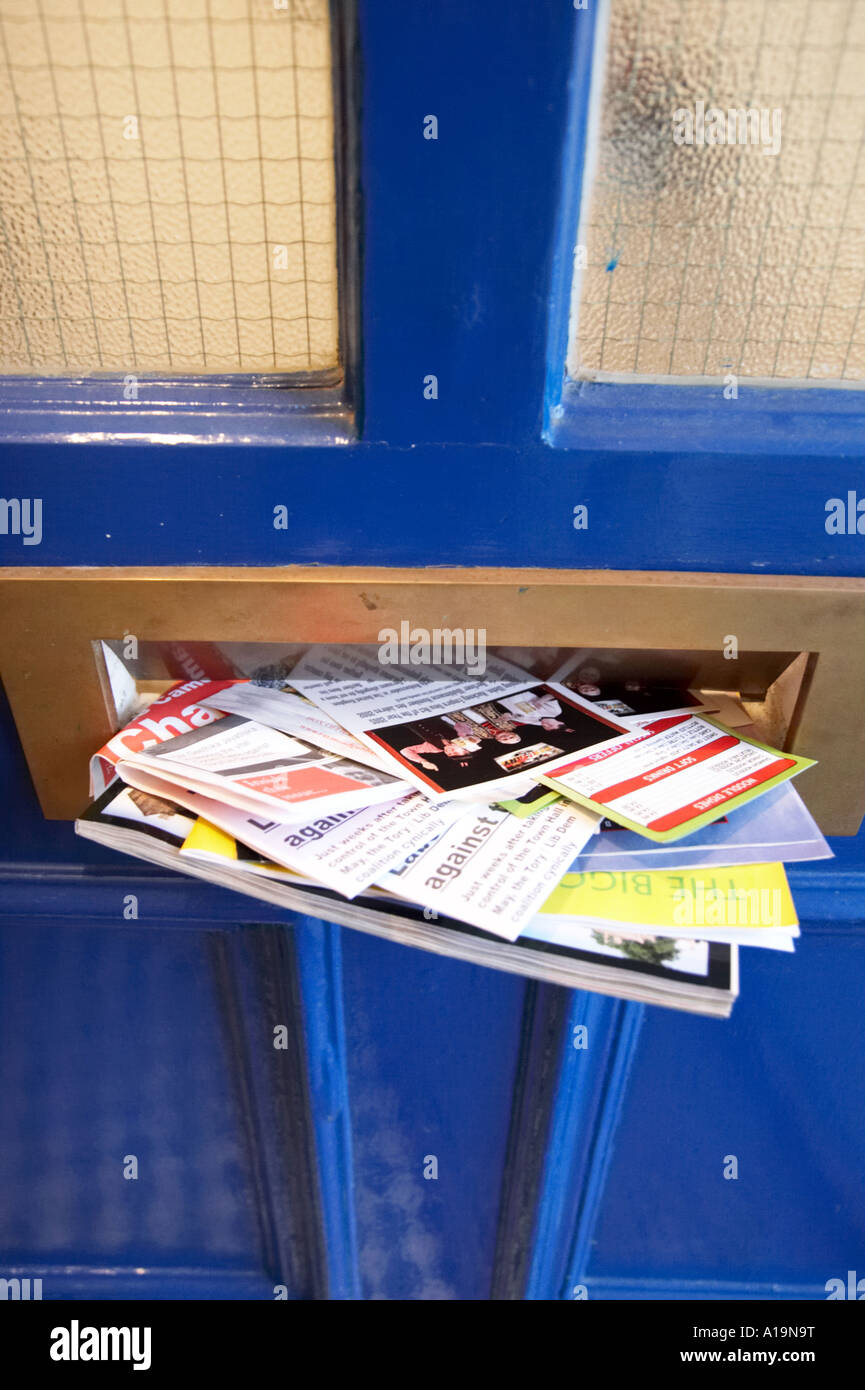 Junk mail through the postbox Stock Photo - Alamy