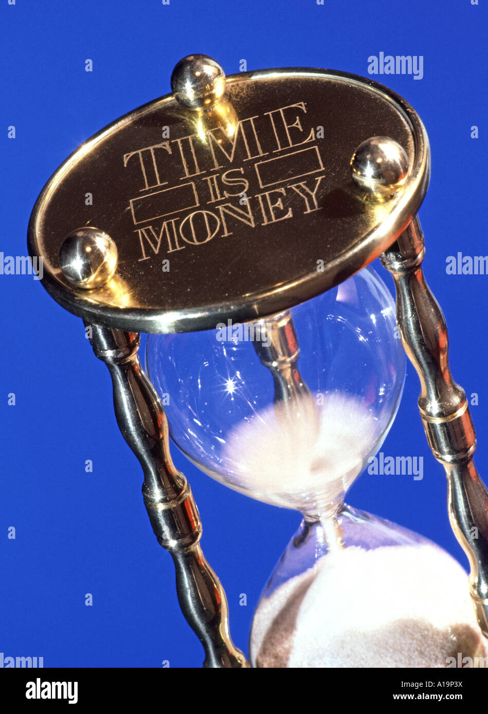 Time is money concept & conceptual ideas image close up of fine white sand passing through egg timer object device time waits for no one man studio uk Stock Photo