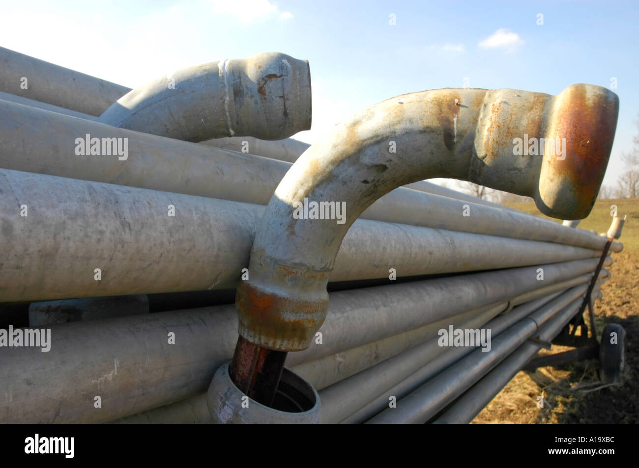 Metal irrigation pipe and fittings stacked on a trailer Stock Photo Alamy