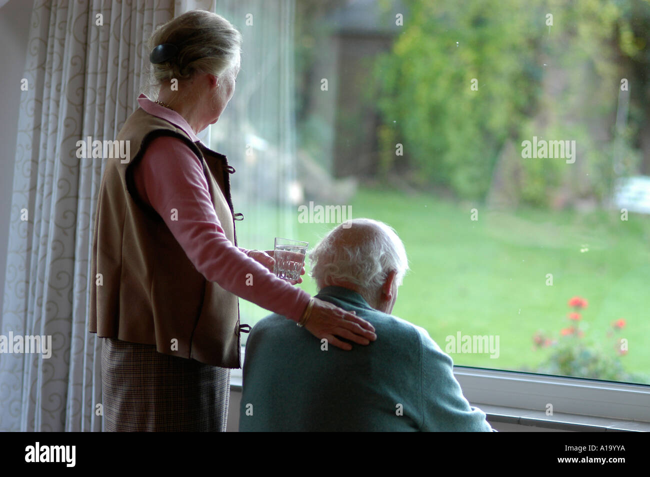 elderly couple at window Stock Photo
