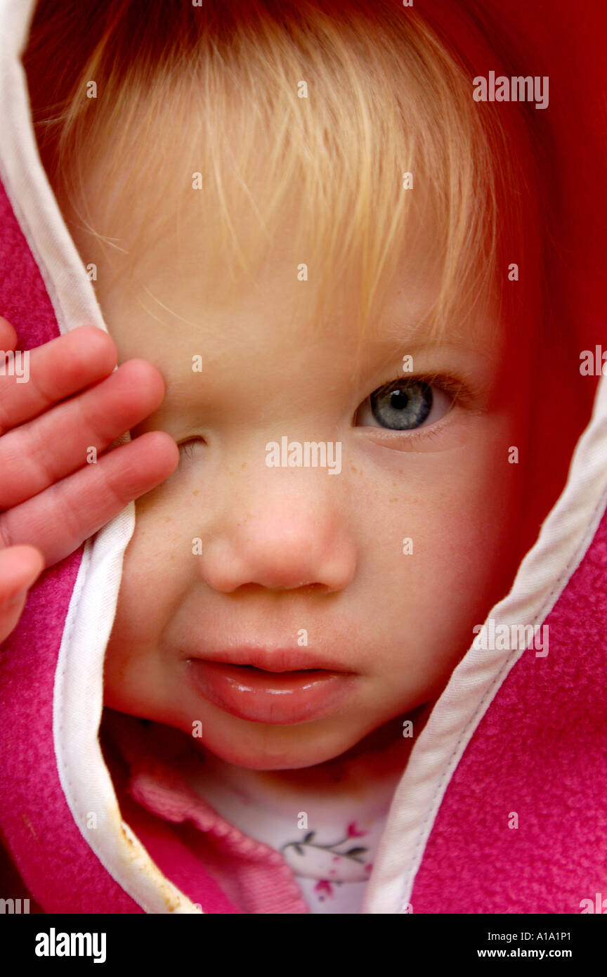 A little girl rubbing her eyes geting ready for a nap Stock Photo Alamy