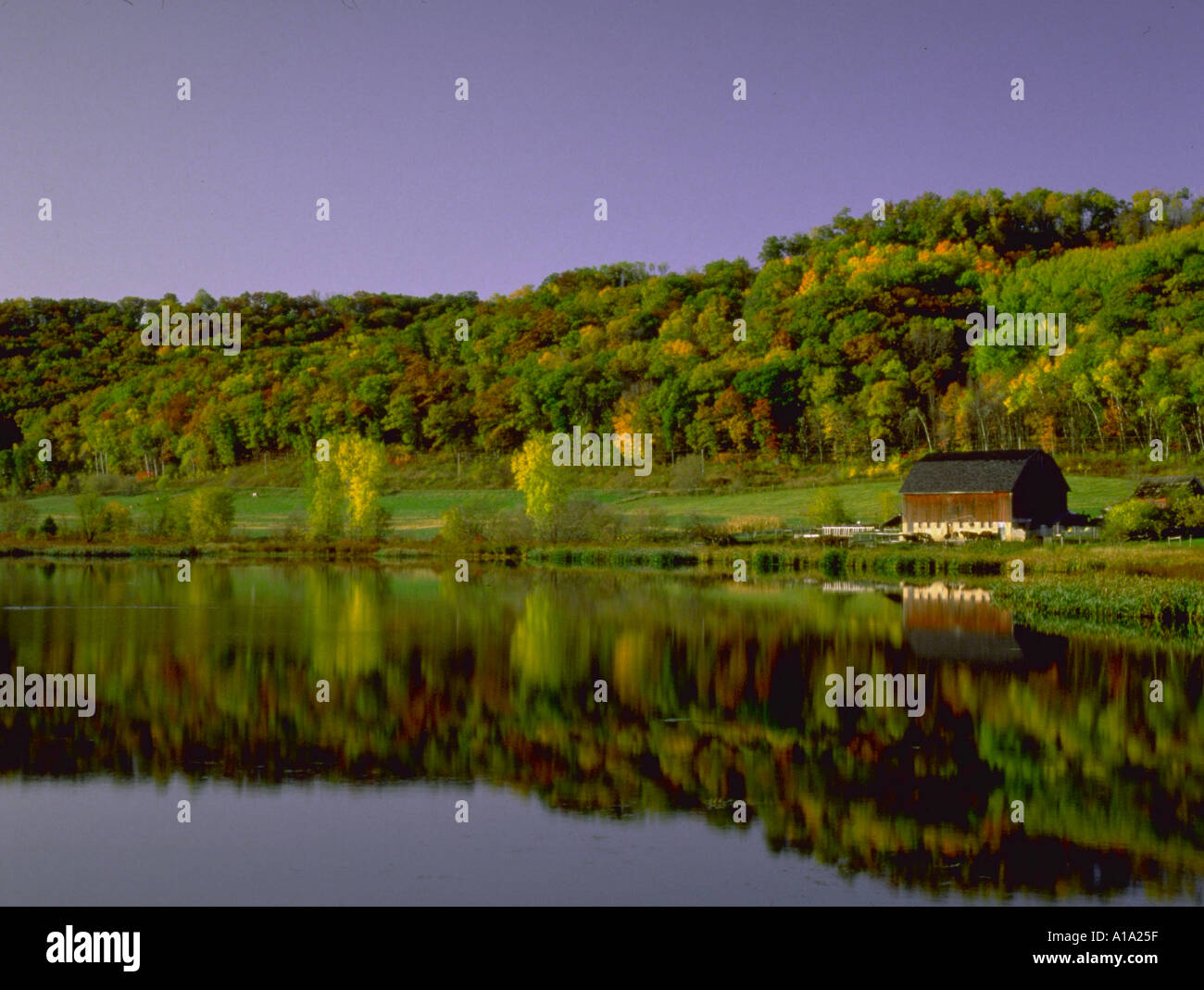 Barn next small pond on rural farm with fall foliage Southeast